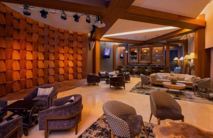 Le Blanc Resort Cancun Adults Only All Inclusive gay-friendly hotel bar lounge area with stage, seating, and warm lighting.