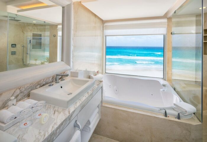 Le Blanc Resort Cancun Adults Only all-inclusive gay-friendly hotel bathroom. Jacuzzi tub with ocean view. Upscale, luxurious.
