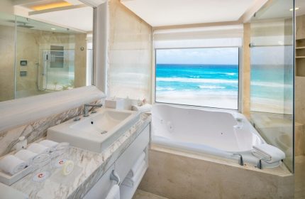 Le Blanc Resort Cancun Adults Only all-inclusive gay-friendly hotel bathroom. Jacuzzi tub with ocean view. Upscale, luxurious.