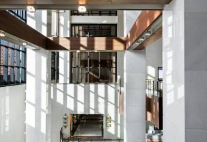 Le Meridien Seoul's interior. The gay-friendly hotel features modern architecture, with white pillars, wood accents, and natural light.