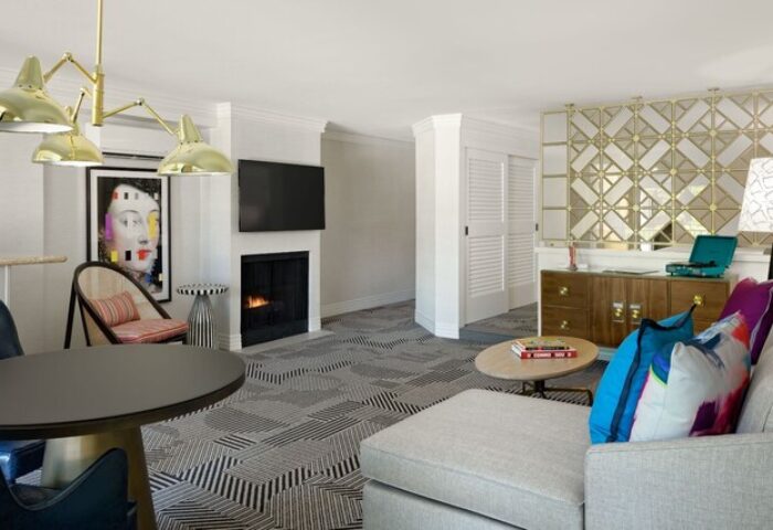 Le Parc at Melrose hotel suite interior. Gay-friendly hotel offers a stylish living room with fireplace, modern art, and comfortable seating.