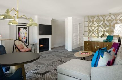 Le Parc at Melrose hotel suite interior. Gay-friendly hotel offers a stylish living room with fireplace, modern art, and comfortable seating.