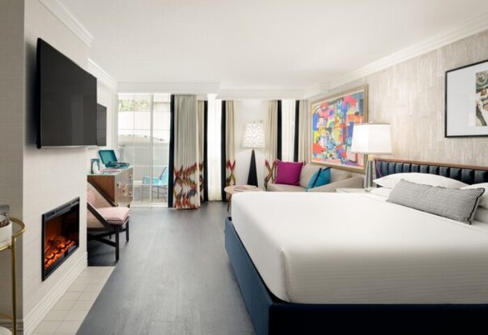 Le Parc at Melrose gay-friendly hotel room. King bed, balcony, fireplace, and colorful art. Upscale lodging for gay travelers in Los Angeles.