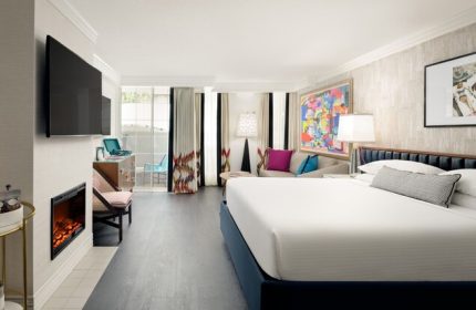 Le Parc at Melrose gay-friendly hotel room. King bed, balcony, fireplace, and colorful art. Upscale lodging for gay travelers in Los Angeles.