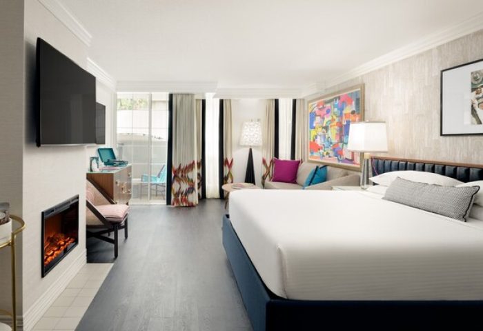 Le Parc at Melrose gay-friendly hotel room. King bed, balcony, fireplace, and colorful art. Upscale lodging for gay travelers in Los Angeles.