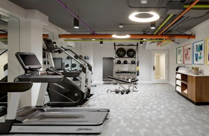Le Parc at Melrose gym with treadmill, weights, and exercise equipment. Gay-friendly hotel fitness center for gay men's travel.