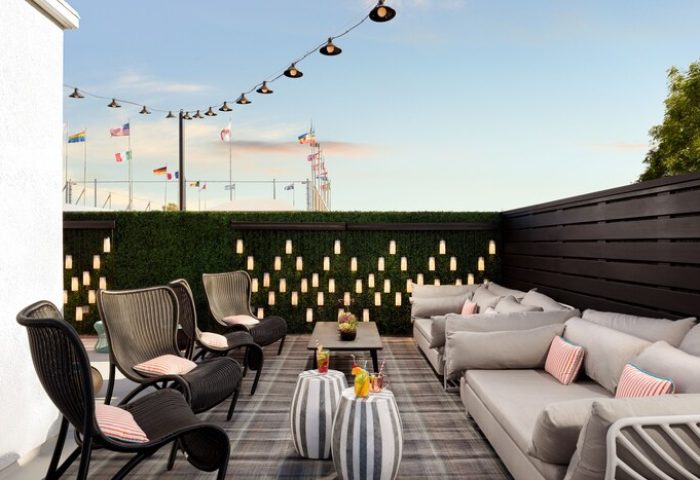 Le Parc at Melrose gay-friendly hotel rooftop. Lounge seating, string lights, and city views. Ideal for gay travel.