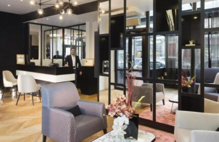 Le Relais du Marais Hotel lobby. Gay-friendly hotel with modern decor, a front desk, and stylish seating. Welcoming space for gay travelers.