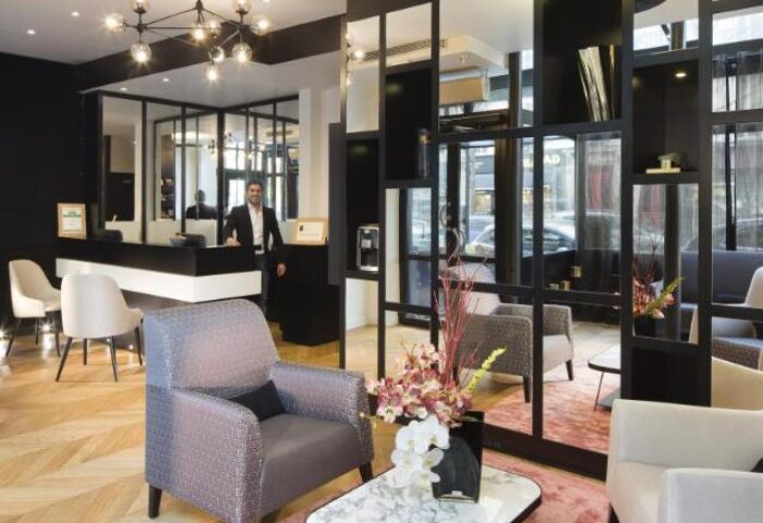 Le Relais du Marais Hotel lobby. Gay-friendly hotel with modern decor, a front desk, and stylish seating. Welcoming space for gay travelers.