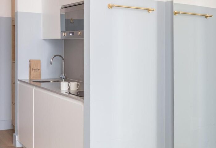 Leman Locke hotel kitchenette. Modern design with sink, microwave, and minimalist decor. Gay-friendly hotel for gay men travel advice.