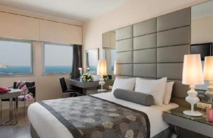 Leonardo Art Tel Aviv By the Beach hotel room. Gay-friendly hotel with sea view. Modern design, comfortable bed, desk, and stylish lamps.