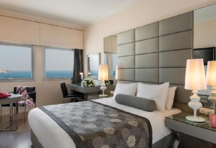 Leonardo Art Tel Aviv By the Beach hotel room. Gay-friendly hotel with sea view. Modern design, comfortable bed, desk, and stylish lamps.