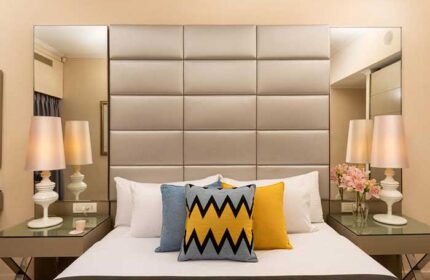 Leonardo Art Hotel Tel Aviv By the Beach bedroom. Gay-friendly hotel room featuring a bed with decorative pillows and bedside lamps.