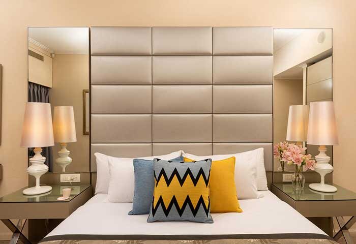 Leonardo Art Hotel Tel Aviv By the Beach bedroom. Gay-friendly hotel room featuring a bed with decorative pillows and bedside lamps.