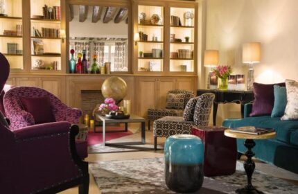 Les Tournelles gay-friendly hotel interior. Cozy lounge area with armchairs, sofa, and decorative elements. A stylish, welcoming space.