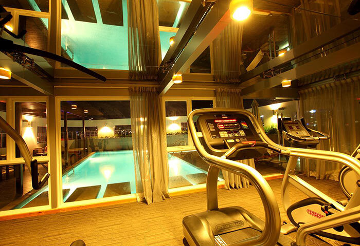 Liberty Central Saigon Centre Hotel gym. Treadmills face a pool. Gay-friendly fitness option in Ho Chi Minh City. Hotel gym.