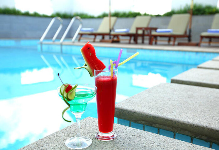 Liberty Central Saigon Centre Hotel's pool with cocktails. Gay-friendly hotel with a refreshing pool and bar. Enjoy Saigon's vibrant scene.