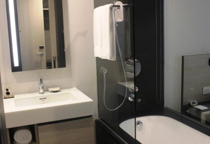Bathroom at Liberty Central Saigon Citypoint Hotel. Modern design with sink, mirror, shower, and tub. Gay-friendly hotel in Saigon.