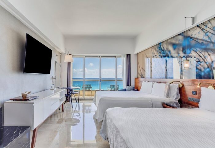 Live Aqua Beach Resort Cancun suite. All-inclusive, adults-only, gay-friendly hotel room with two beds and ocean view balcony.