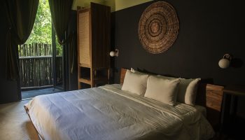 Loba Tulum Male Only gay-friendly hotel room. Bed, balcony, and rustic decor create a relaxing vibe for gay travelers in Tulum.