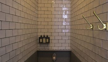 Shower in Loba Tulum Male Only, a gay-friendly hotel. Features include tile, stone floor, shower head, hooks, and toiletries. Great for gay travel.