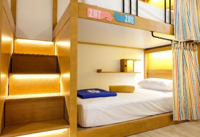 Lub D Koh Samui Chaweng Beach gay-friendly hotel dorm. Bunk bed with stairs, colorful curtains, & room numbers. Perfect for gay travelers.