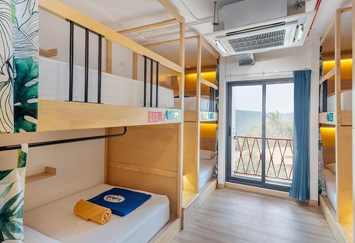 Lub D Koh Samui Chaweng Beach gay-friendly hotel. Hostel dorm room with bunk beds, balcony view. Modern, clean, and inviting space.
