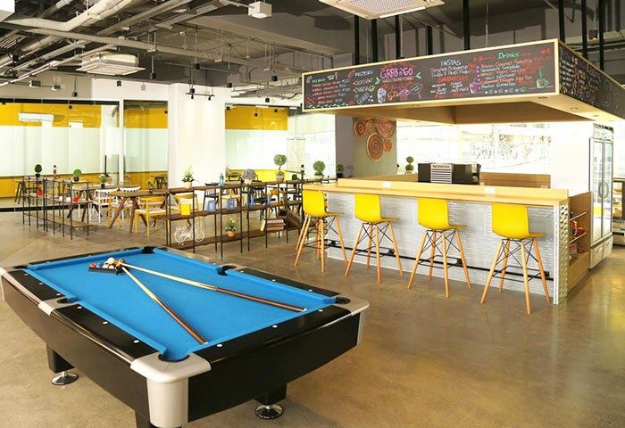 Lub D Philippines Makati interior. Gay-friendly hotel bar with pool table, yellow stools, and menu board. Great for gay travel in Makati.