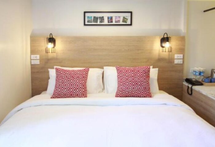 Lub D Philippines Makati gay-friendly hotel room. Bed with red patterned pillows, lamps, & decor. Ideal for gay travel in Makati.