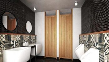 Lub d Phuket Patong gay-friendly hotel bathroom. Modern design with urinals, sinks, mirrors, patterned tiles, and wooden stall doors.