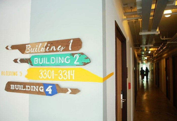 Lub d Phuket Patong hotel hallway with colorful building signs. Gay-friendly hotel with cool design elements. Interior of Patong hotel.