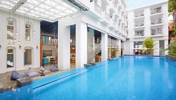 Lub d Phuket Patong hotel pool view. Modern design, white building. Gay-friendly travel destination in Thailand. Spiral staircase, bean bags.