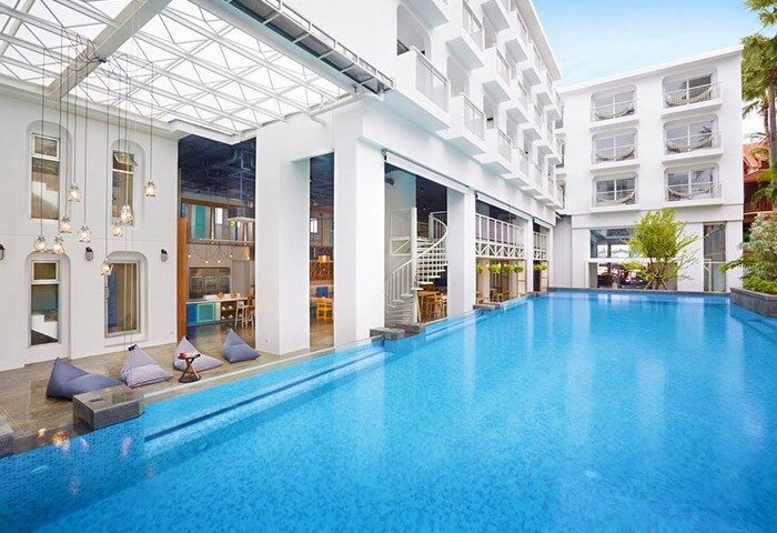 Lub d Phuket Patong hotel pool view. Modern design, white building. Gay-friendly travel destination in Thailand. Spiral staircase, bean bags.