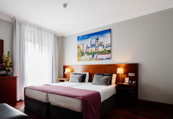 Hotel Infantas by MIJ, gay-friendly, pet-friendly luxury hotel room. Double bed, Madrid art, wood floors. Ideal for gay travel in Madrid.