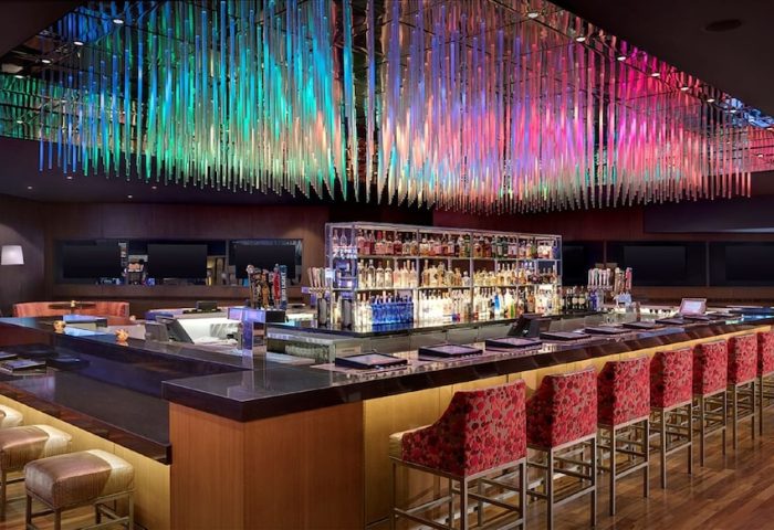 Luxor Hotel's bar with colorful ceiling decor. A gay-friendly hotel, it's a great spot for gay men's travel, offering a welcoming atmosphere.