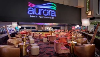 Aurora Bar at Luxor Hotel, a gay-friendly hotel in Las Vegas. The lounge has stylish seating and a modern design.