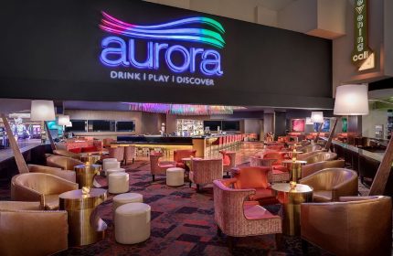 Aurora Bar at Luxor Hotel, a gay-friendly hotel in Las Vegas. The lounge has stylish seating and a modern design.