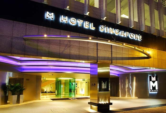 M Hotel Singapore entrance. Gay-friendly hotel with modern design, purple lighting, and sleek architecture. A top choice for gay travelers.