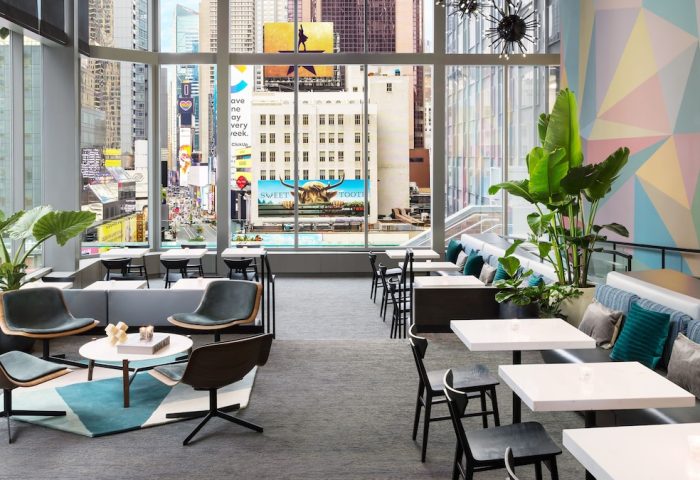 M Social Times Square hotel lounge area with city views. A gay-friendly hotel with modern design and vibrant atmosphere. Perfect for gay travel.