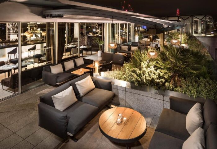 ME London Hotel's rooftop bar at night. Gay-friendly and pet-friendly, the luxury hotel offers stylish seating and city views.