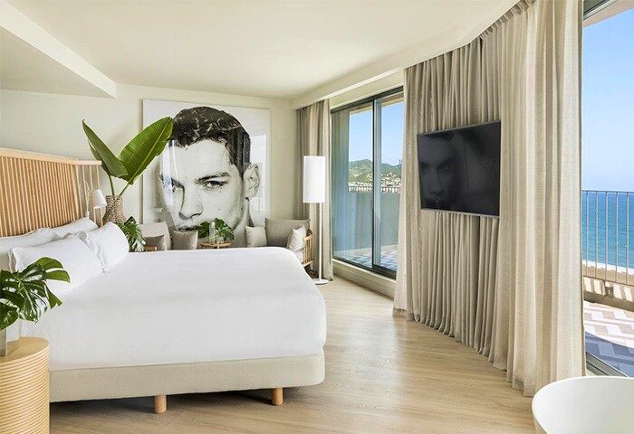 ME Sitges Terramar gay-friendly hotel room. Modern design, balcony with ocean view. Pet-friendly option for gay travel in Sitges, Spain.
