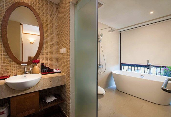 Bathroom at MK Premier Boutique Hotel, a gay-friendly hotel. Features a modern sink, bathtub, shower, and stylish design. Ideal for gay travel.