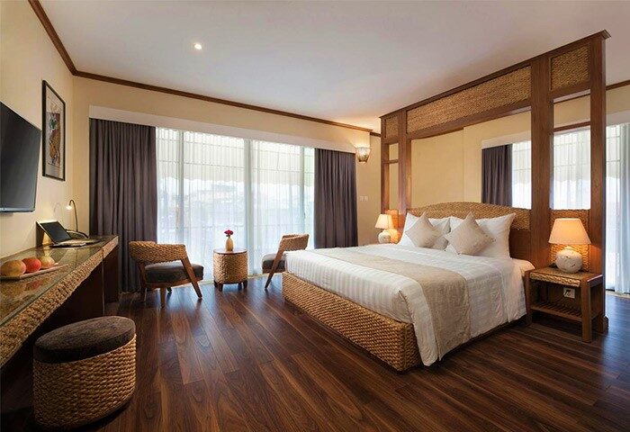 MK Premier Boutique Hotel room. Gay-friendly hotel with a bed, desk, chairs, and a large window. Stylish, comfortable, and welcoming.
