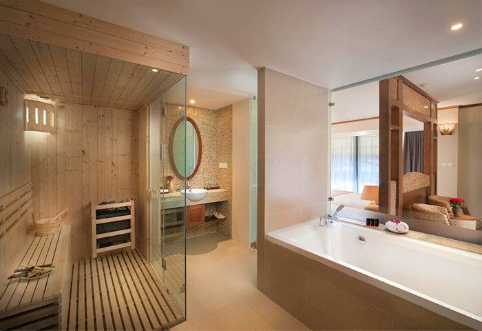 MK Premier Boutique Hotel gay-friendly room. Features a sauna, sink, bathtub, and bed. A luxurious stay for gay travelers.