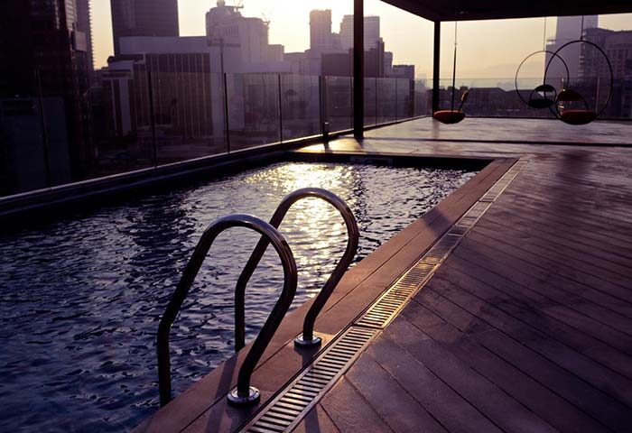 MOV Hotel's rooftop pool for gay travelers. City views, stylish seating, and a pool ladder. A gay-friendly hotel for a memorable vacation.