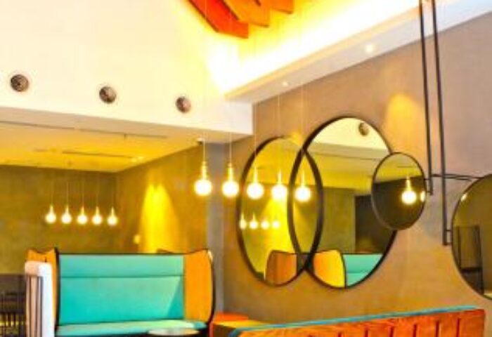 MOV Hotel's gay-friendly design: Stylish lounge area with colorful seating, unique lighting, and modern decor. A welcoming space for gay travelers.
