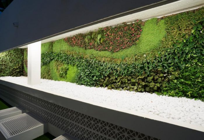 MS Aguamarina Suites gay-friendly hotel vertical garden. Outdoor wall with plants, flowers, and white stones. Modern design at this gay hotel.