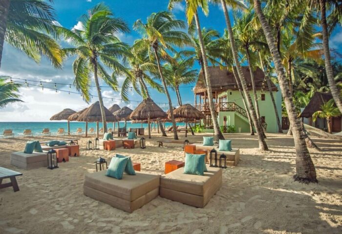 Mahekal Beach Front Resort and Spa: Gay-friendly hotel with beachside seating, palm trees, and ocean views. Perfect for gay men's travel.