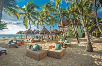 Mahekal Beach Front Resort and Spa: Gay-friendly hotel with beachside seating, palm trees, and ocean views. Perfect for gay men's travel.