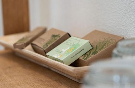 Bathroom amenities at Mainhaus Stadthotel, a gay-friendly hotel in Frankfurt. Eco-friendly toiletries on a wooden tray. Sustainable travel.
